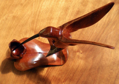 Ruby-throated hummingbird in mahogany with ruby inset