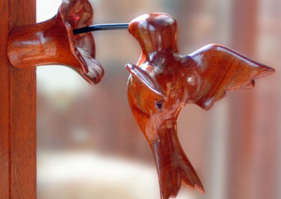 Ruby-throated hummingbird in mahogany with ruby inset